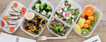 Healthy meal prep boxes with fresh fruits